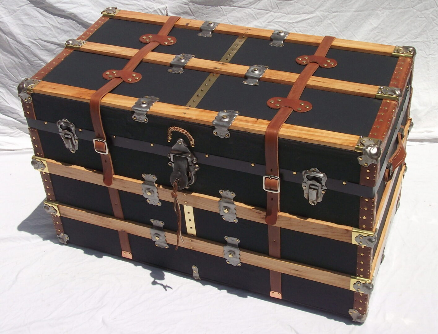 Vintage black steamer trunk with leather straps
