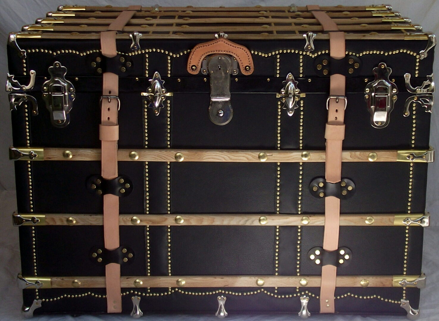 Black vintage steamer trunk with brass hardware