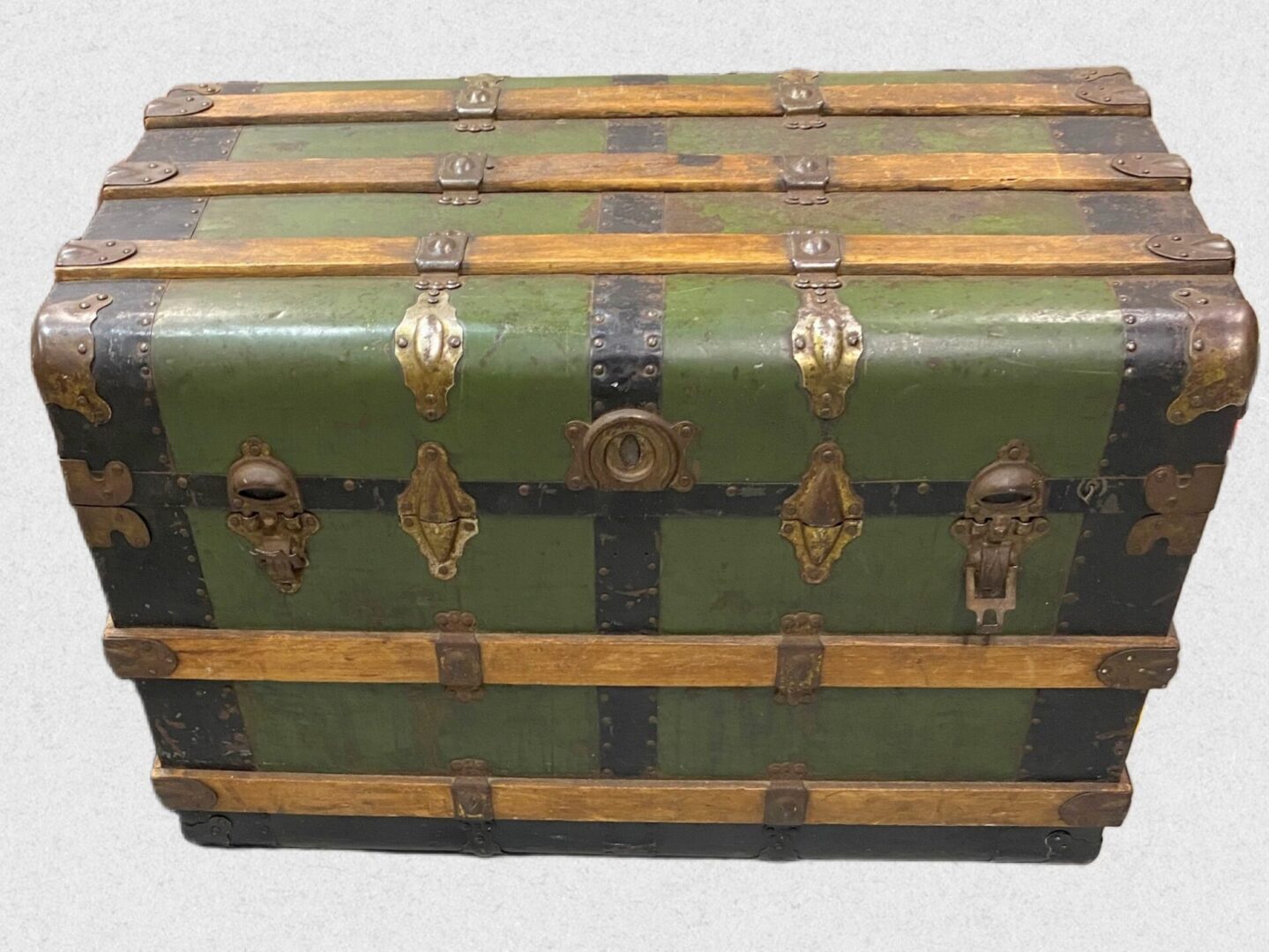 Vintage green steamer trunk with brass fittings