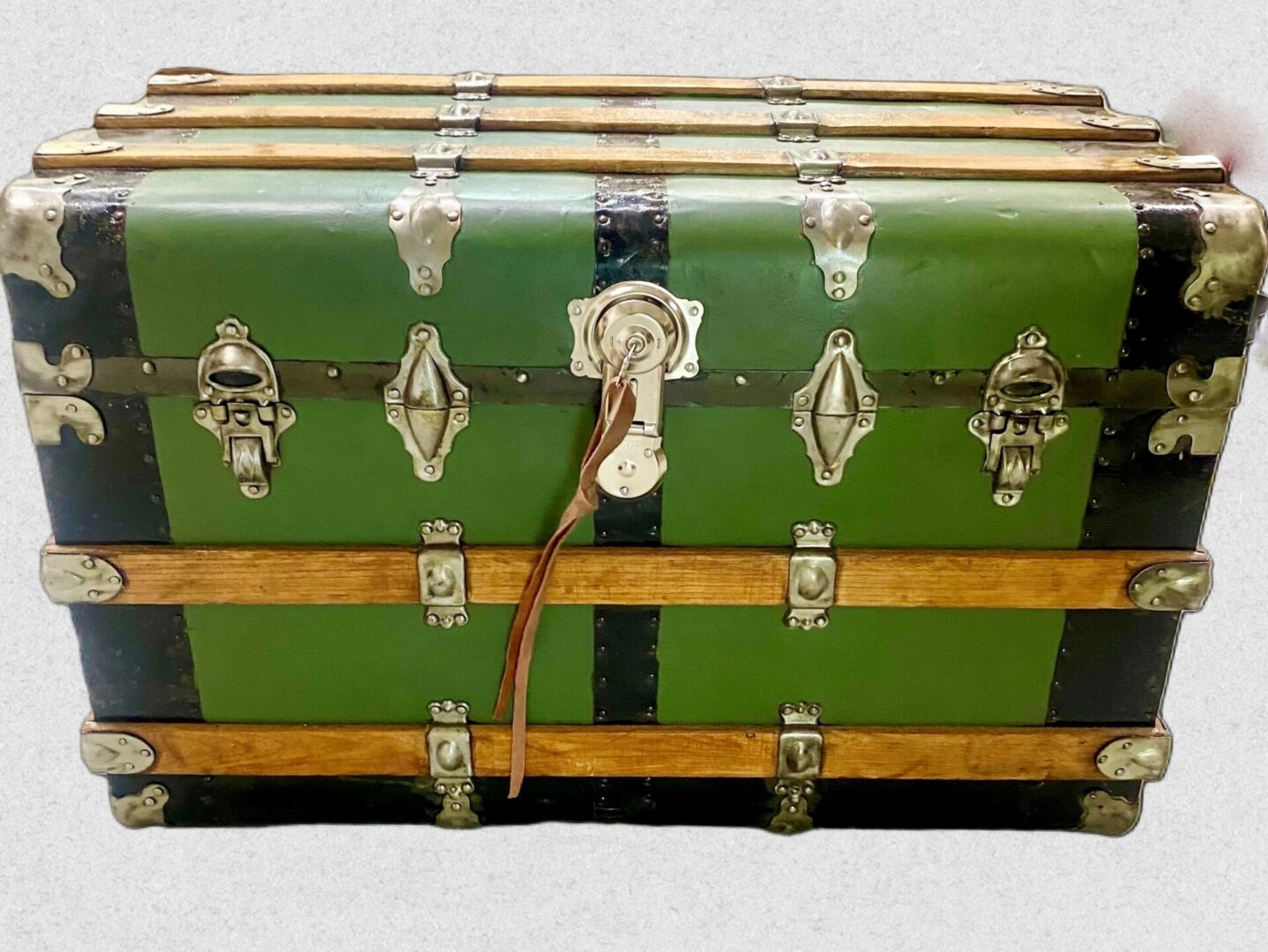 Antique green steamer trunk with leather strap