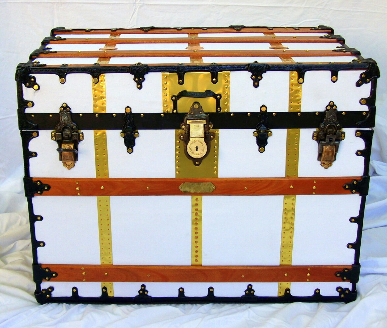 White vintage steamer trunk with brass accents